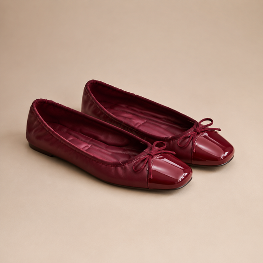 Paar bordeauxrode ballerina's met glanzende vierkante neus en strik.